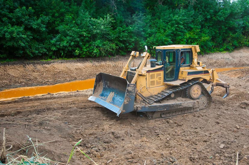Excavator performing mechanical site preparation for reforestation